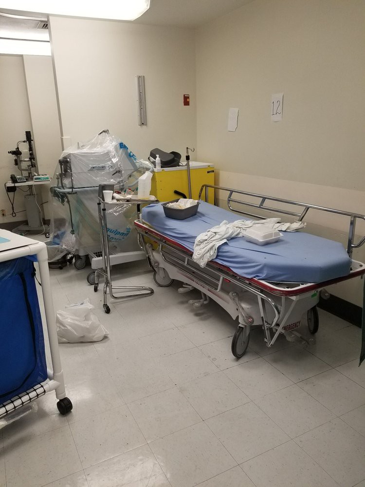 A hospital room with medical equipment and a bed.
