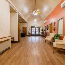 A spacious hallway with wooden flooring and comfortable seating.