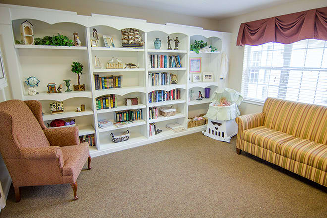 A cozy reading area with bookshelves and comfortable armchairs.