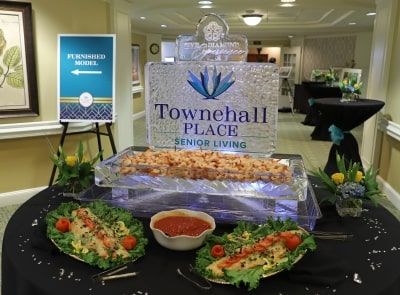 Buffet setup featuring an ice sculpture at Townehall Place Senior Living event.