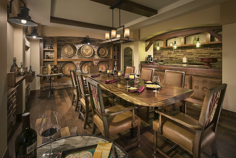A rustic dining room featuring wooden furniture and wine barrels, creating a cozy and inviting atmosphere.