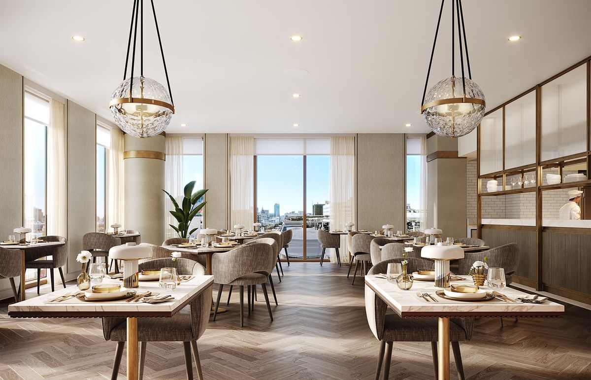 A modern and elegant restaurant dining area with stylish chandeliers, featuring natural lighting and neatly arranged tables and chairs.