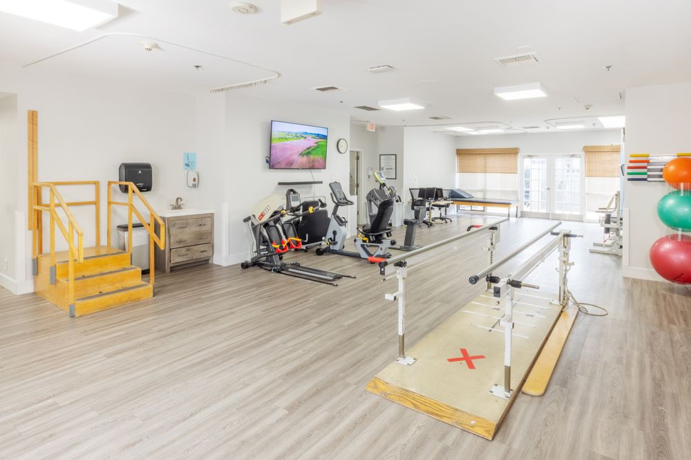 A well-equipped physical therapy clinic featuring exercise machines and rehabilitation equipment.