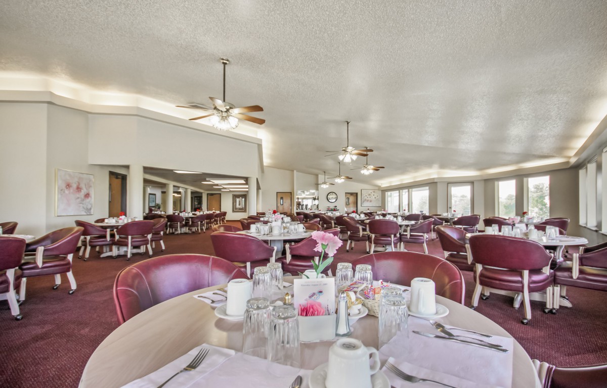 Spacious dining area with tables and chairs neatly arranged.
