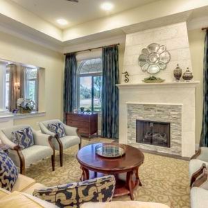 A well-decorated living room with a fireplace and elegant furnishings.