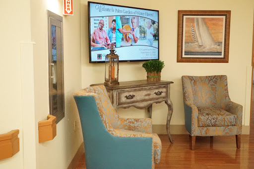 A cozy and inviting waiting area featuring comfortable seating, a decorative table, and a television displaying engaging content.