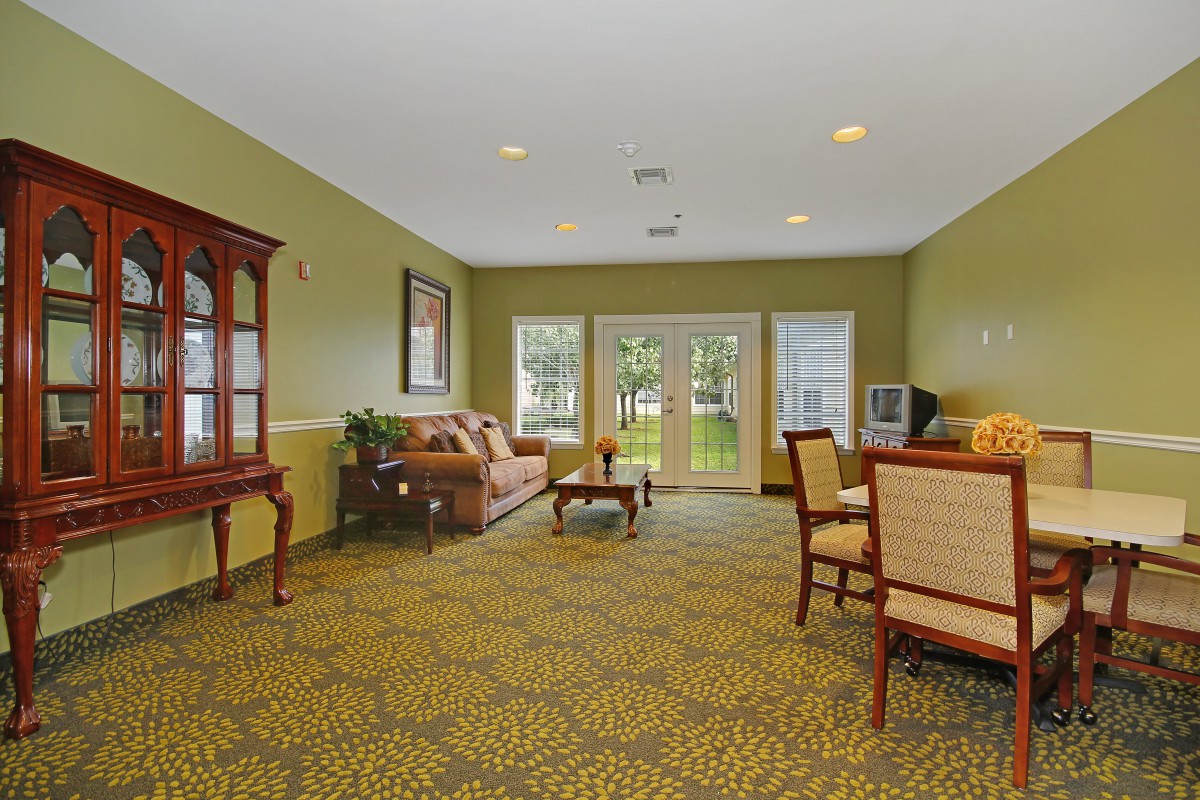 A cozy living room with comfortable seating and a view of the outdoors.