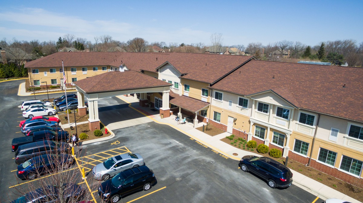 Aerial view of a large building with an attached parking lot.
