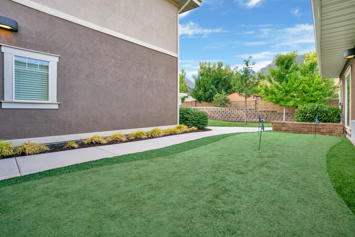 Well-maintained backyard with manicured lawn and garden.