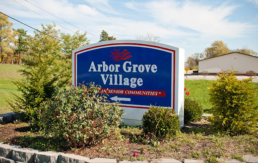 Welcome sign for Arbor Grove Village, showcasing its community features.