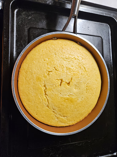 Freshly baked cornbread cooling in the pan.