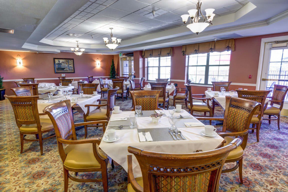 Elegant dining room with neatly arranged tables and chairs.