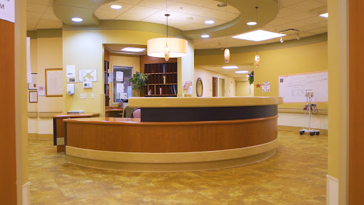 A welcoming reception area in a healthcare facility, featuring modern design and a warm color palette.