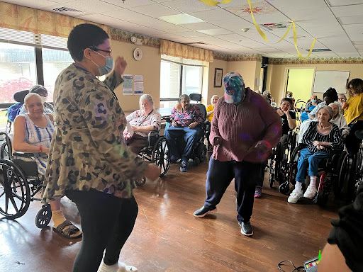 Residents at a community center enjoying a lively dance session.