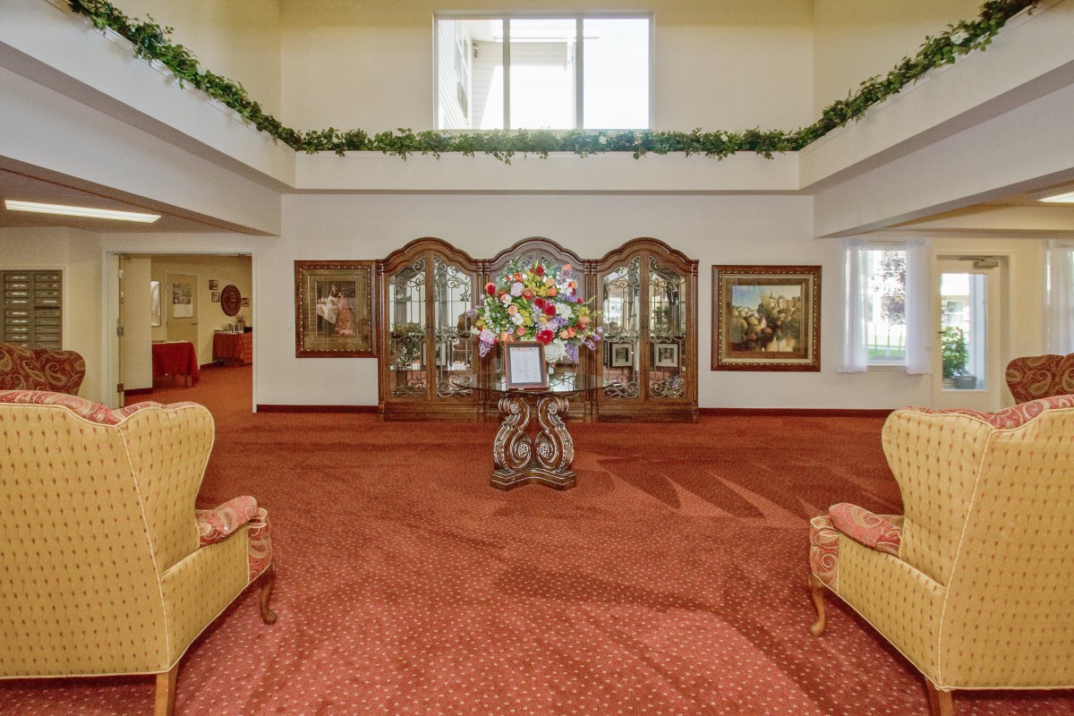 A beautifully decorated lobby with elegant furniture and floral arrangements.