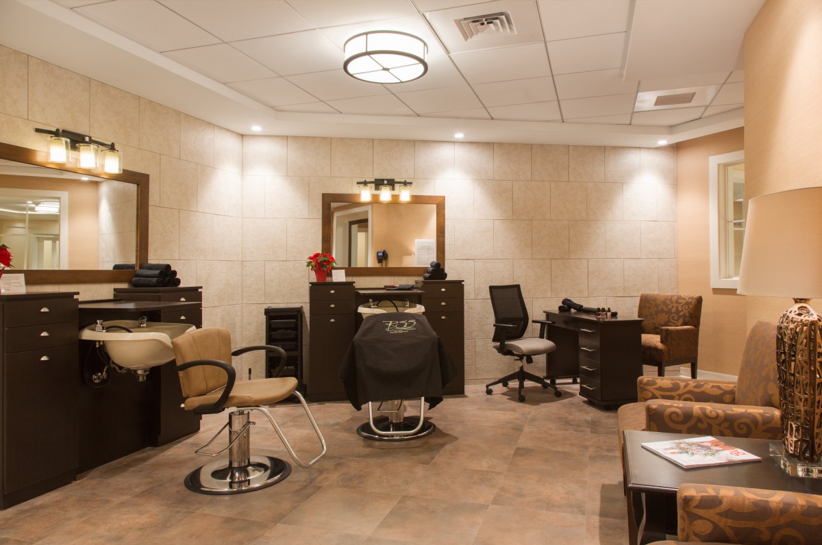 A modern salon interior with chairs, mirrors, and stylish lighting.
