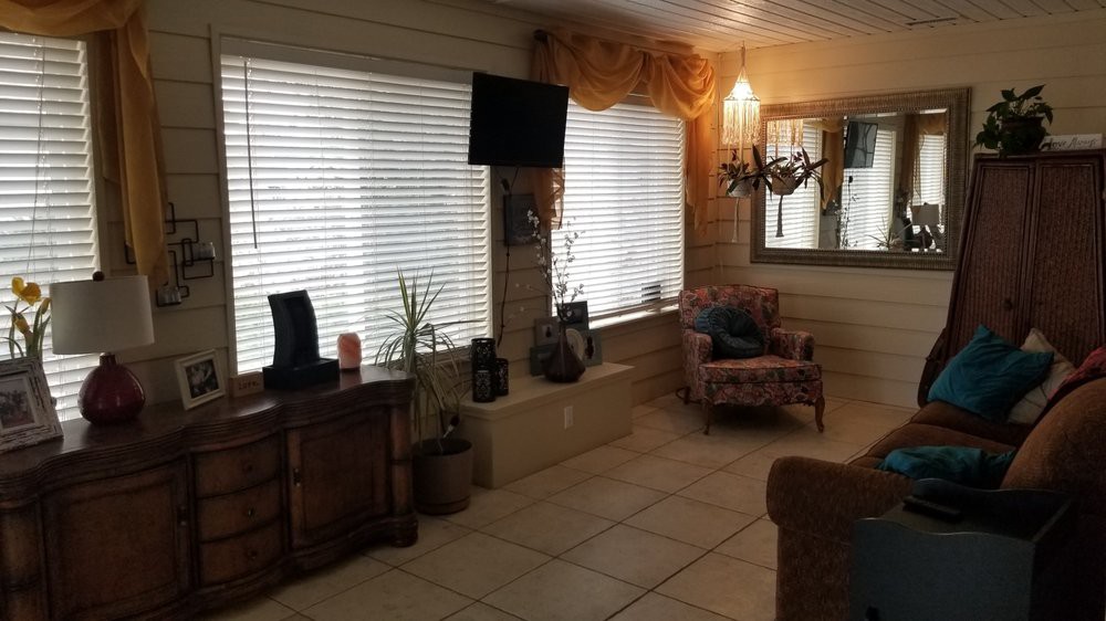 A cozy living room with large windows and comfortable seating.