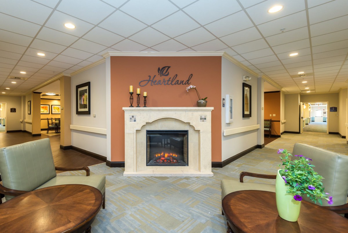 A cozy lobby area with a decorative fireplace and comfortable seating.