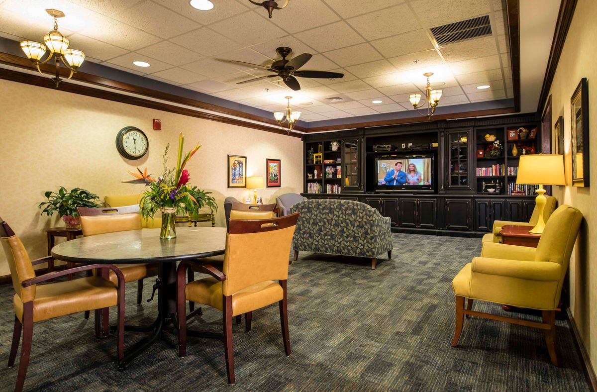 A cozy lounge area with comfortable seating, a television, and tasteful decor.