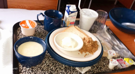 A simple breakfast setup featuring various food items on a table.