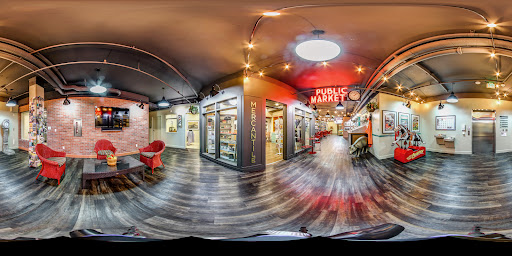 A vibrant public market featuring various food stalls and a modern interior design.