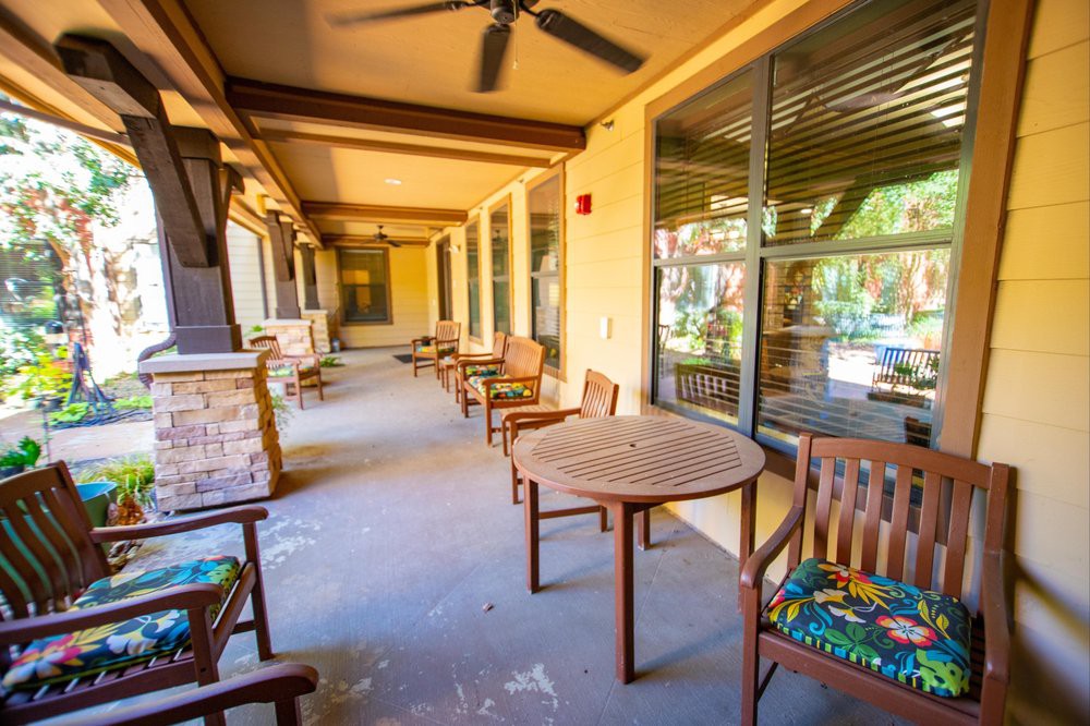 A cozy outdoor patio with wooden tables and chairs, perfect for relaxation.