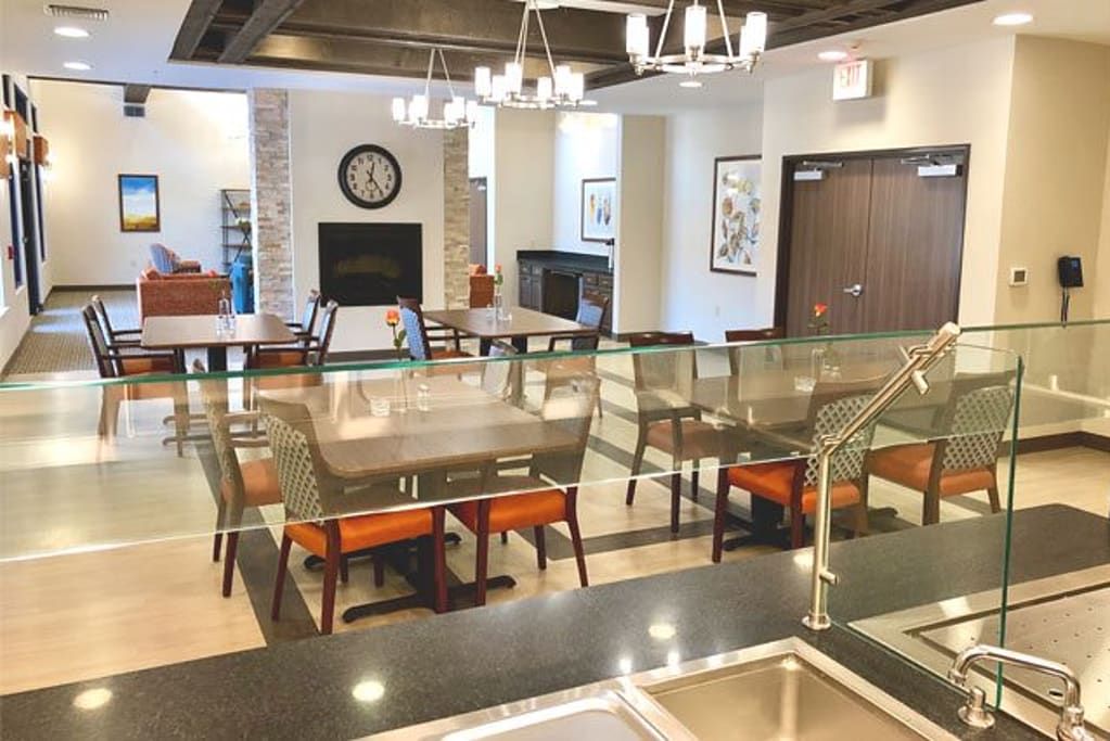 A modern dining area with comfortable seating, elegant chandeliers, and tasteful decor.