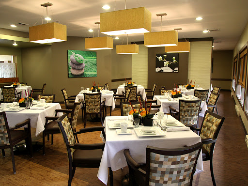 A cozy dining area with neatly arranged tables and chairs, perfect for an inviting meal.