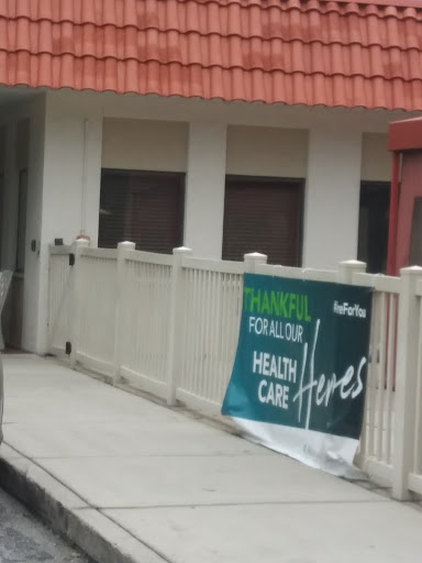 A banner promoting health care services displayed outside a building.