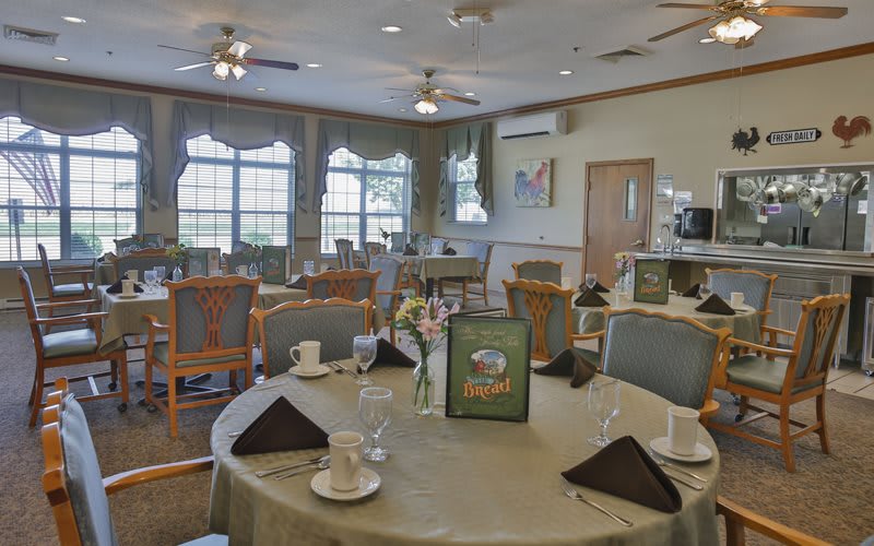 A restaurant dining area with neatly arranged tables and chairs.