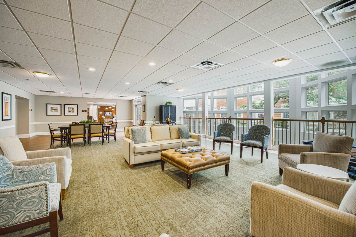 A modern lounge area with comfortable seating and large windows.