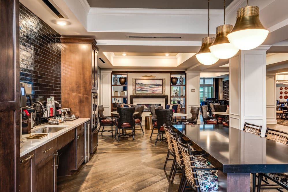 A modern kitchen and dining area with a bar and cozy seating arrangements.