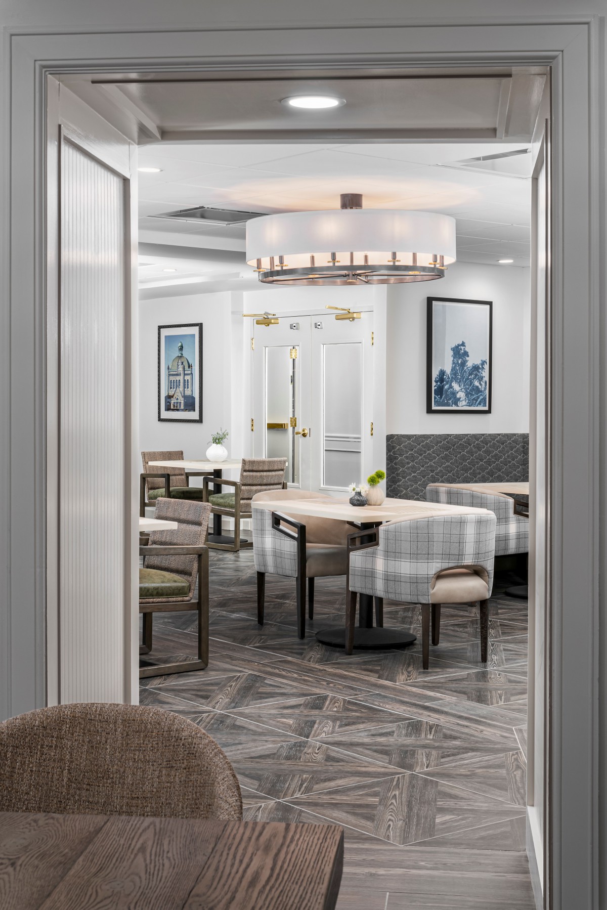 A modern dining area with elegant furnishings and a stylish chandelier.