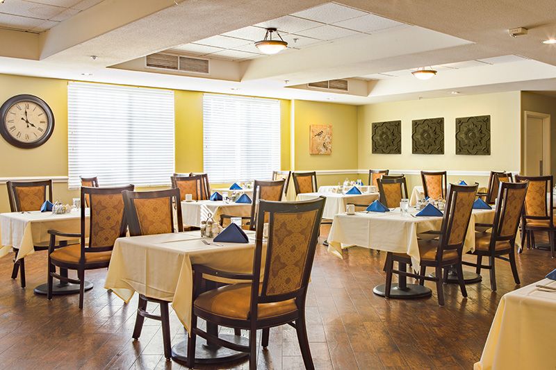 A well-arranged restaurant dining area with neatly set tables and chairs.