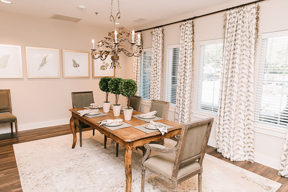 A beautifully decorated dining room with an elegant table setting and a chandelier.