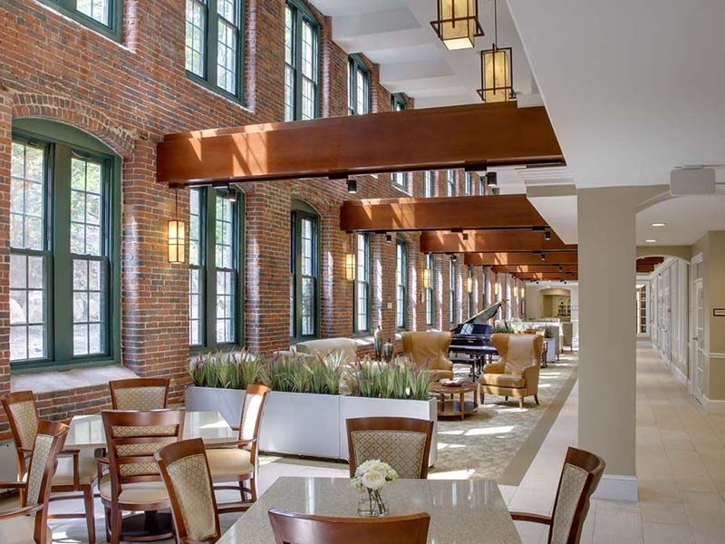 A spacious and modern dining area with stylish furniture and large windows.