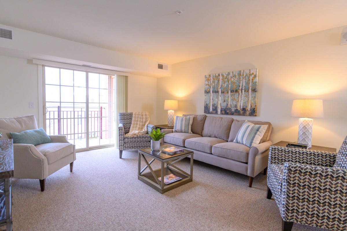 A cozy living room with a comfortable sofa, armchairs, and stylish decor.