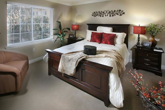 A cozy bedroom with elegant decor and warm lighting.