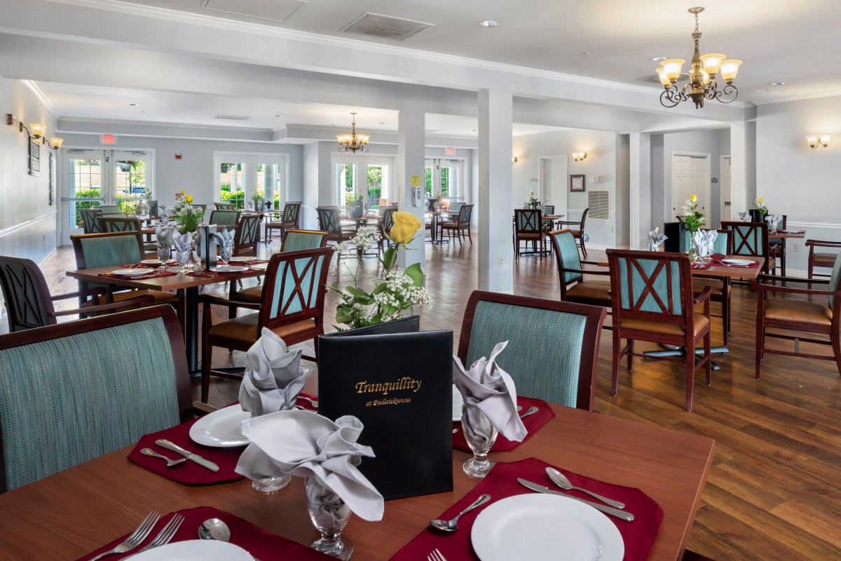 An elegant dining area set with tables and chairs, ready for guests.