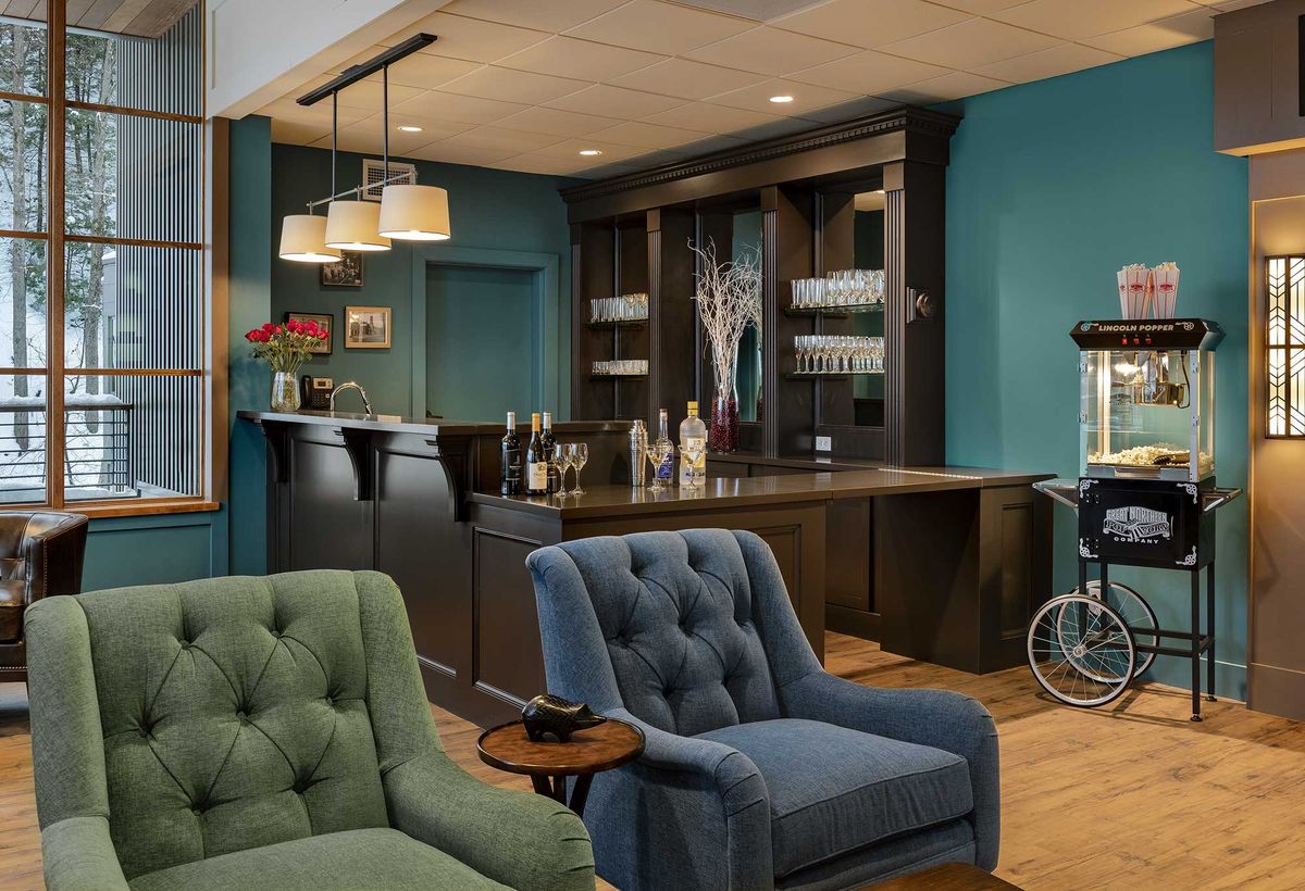 A cozy lounge area with plush seating and a modern bar setup.