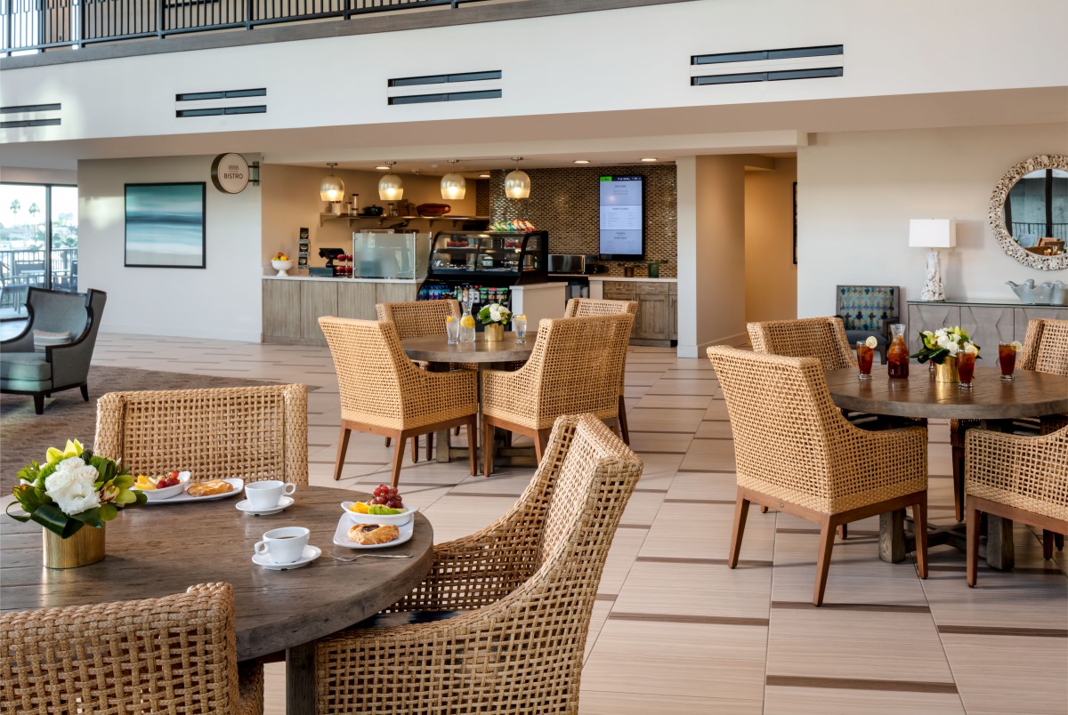 A modern cafe interior with rattan furniture and a welcoming atmosphere.