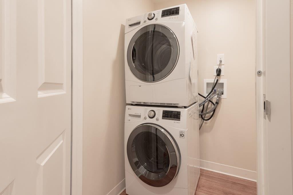 Stacked washer and dryer in a compact laundry space.