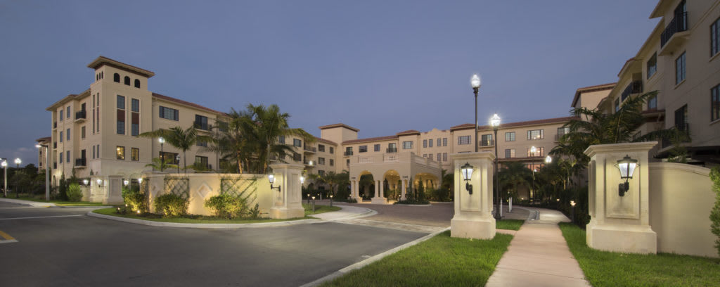A well-lit residential building entrance at dusk.