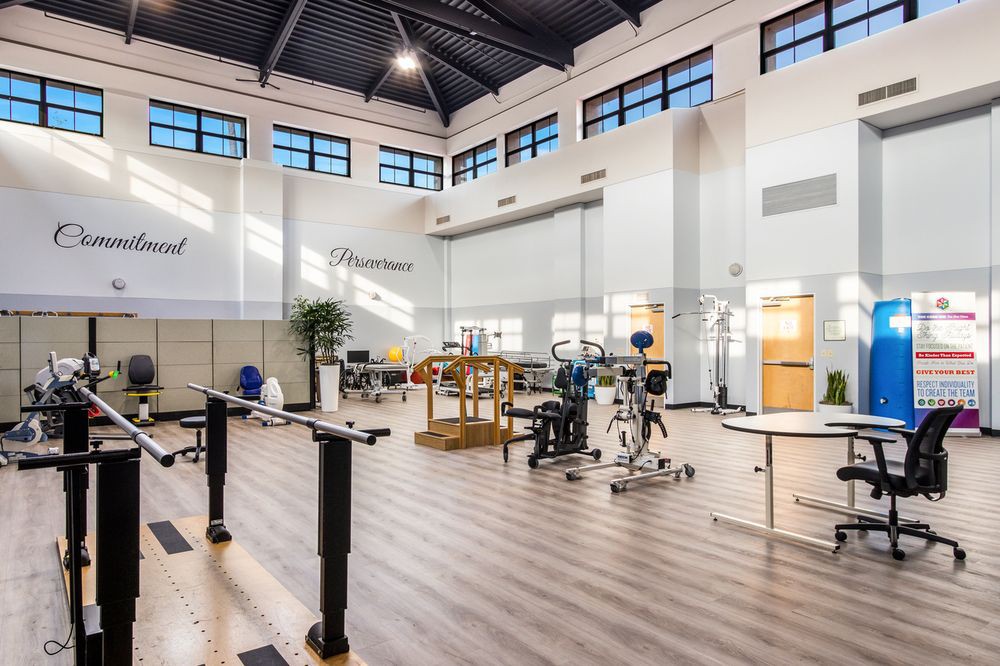 A spacious and well-lit fitness center equipped with various exercise machines and modern facilities.
