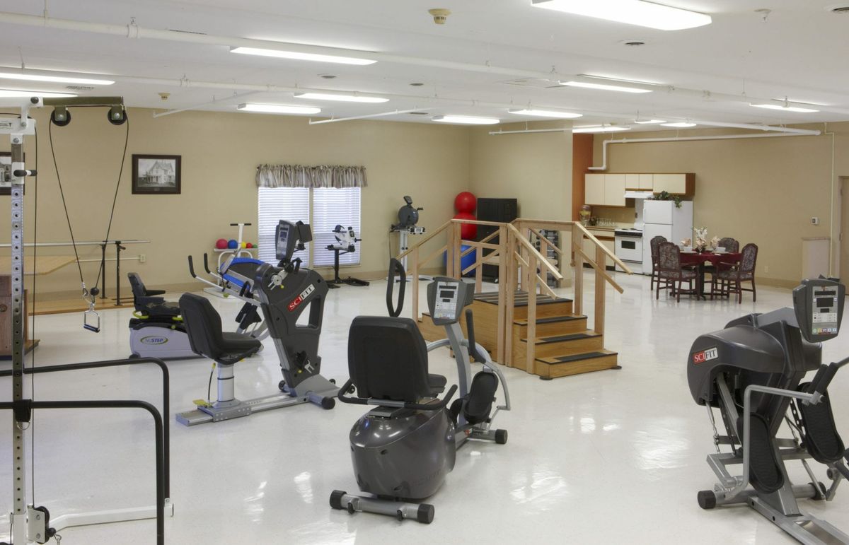 A well-equipped rehabilitation room with various exercise machines and therapy tools for physical therapy.