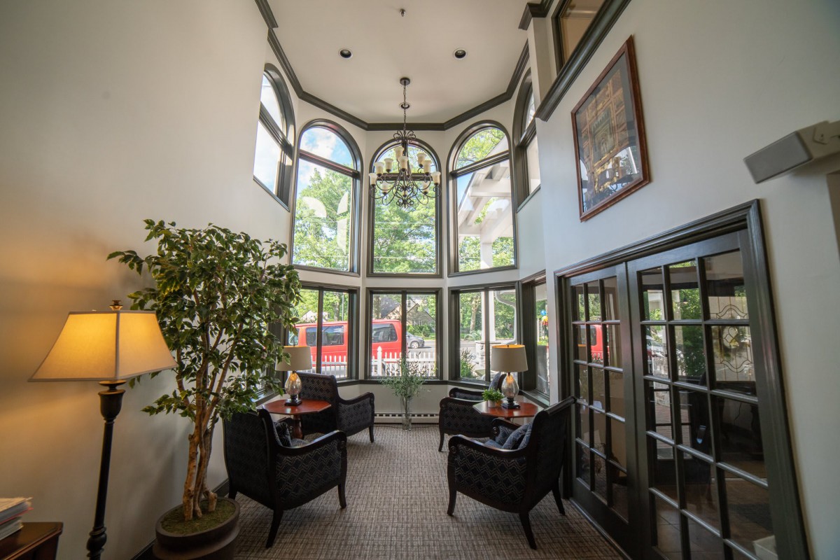 A cozy seating area with large windows allowing natural light to fill the space.