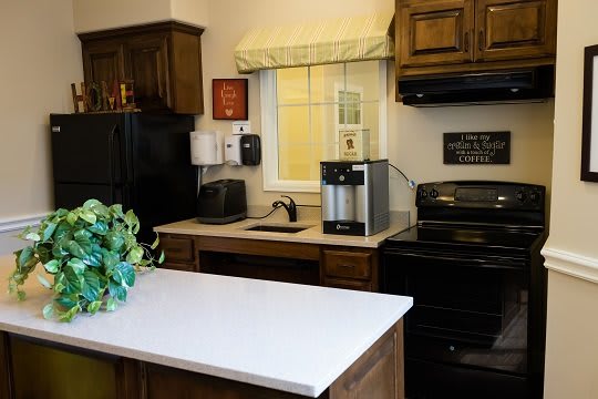 A cozy kitchen with modern appliances and wooden cabinetry.