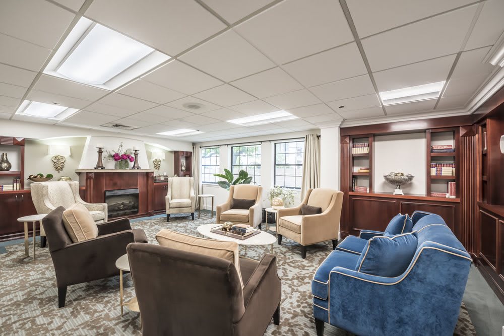 A cozy living room with ample seating arrangements and a fireplace.