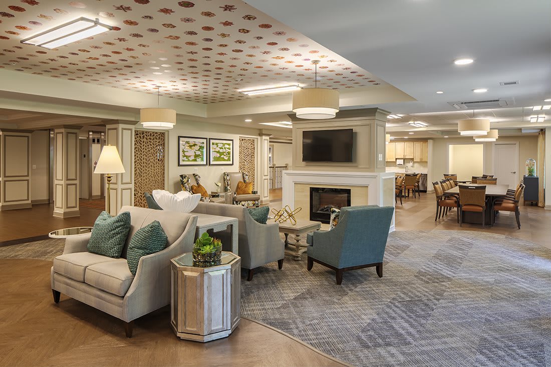 A modern and elegantly designed living room featuring comfortable seating, a fireplace, and stylish decor.