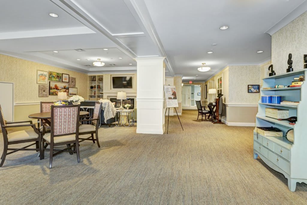 A spacious and well-decorated living area with modern furniture and ambient lighting.